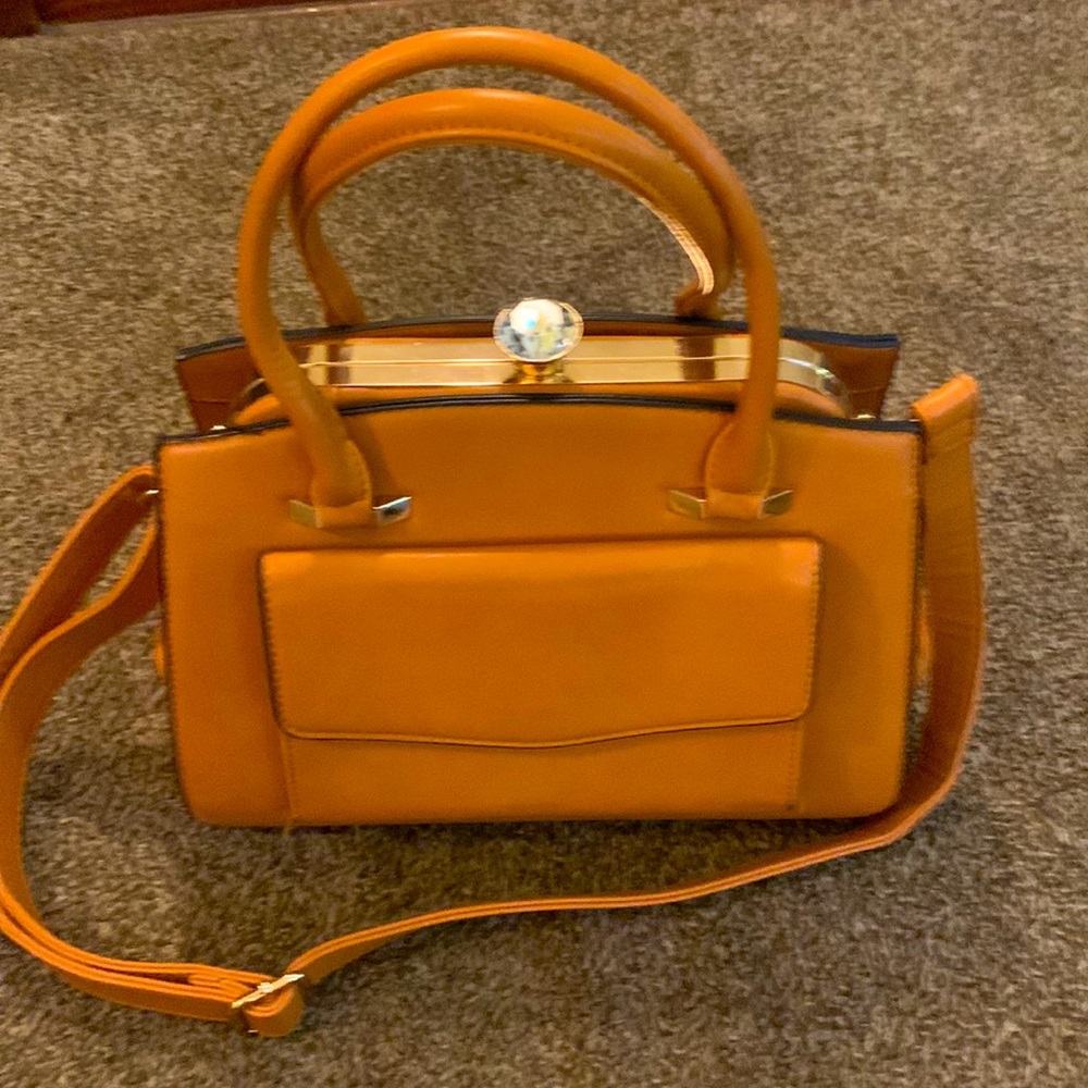 Brown purse with bejeweled clasp